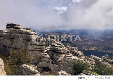 A mystical morning walk through the rocky landscapes of Torcal de Antequera in Andalusia, Spain, as soft mist drifts under the gentle rays of the sun. A mystical morning walk through the rocky landscapes of Torcal de Antequera in Andalusia, Spain, as soft mist drifts under the gentle rays of the sun. 143017306