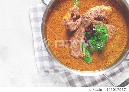 fesenjan, an Iranian dish, stewed chicken, in a nut-pomegranate sauce, in a saucepan,light background, homemade, no people, 143017687