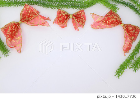 background Christmas festive border with red bows and pine branches 143017730