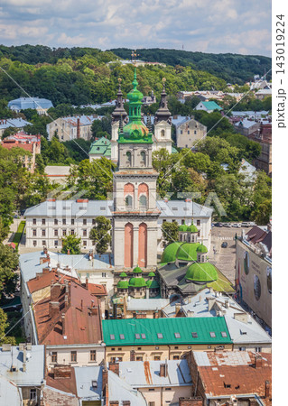 Old city view with stone church featuring green dome and towers Old city view with stone church featuring green dome and towers 143019224
