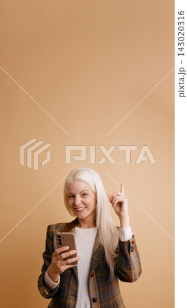 Mature woman finding creative idea using smartphone Mature woman finding creative idea using smartphone 143020316