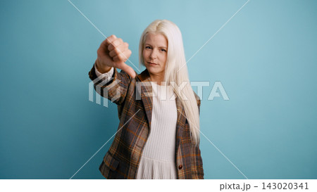 Woman giving thumbs down expressing disapproval 143020341
