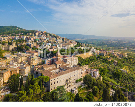 Aerial view of historic Tivoli in Lazio, Italy, with dense town architecture surrounded by green hills and countryside near Rome. 143020878