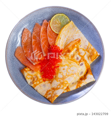 Thin pancakes with caviar and salmon on a plate Thin pancakes with caviar and salmon on a plate 143022709