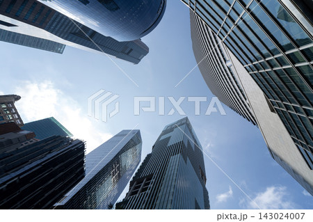 Singapore CBD skyscrapers towering above captured from dramatic low angle perspective 143024007