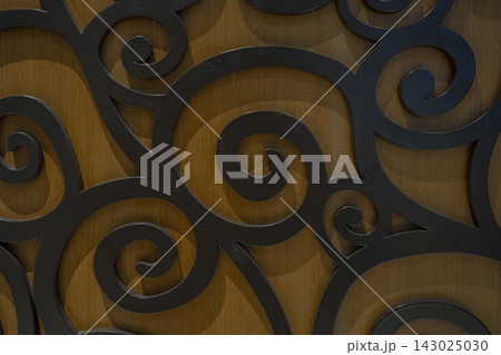 Black iron arabesque ornament pattern on wood background Black iron arabesque ornament pattern on wood background 143025030