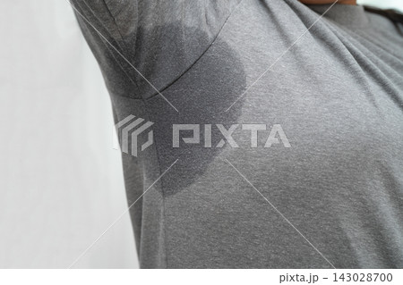 Sweaty underarms, Asian woman with sweat on clothes under armpit. Sweaty underarms, Asian woman with sweat on clothes under armpit. 143028700