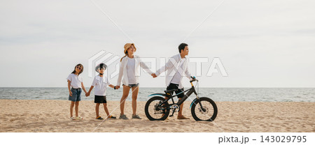 Parents and children enjoy a beach stroll with bicycles a scene full of happiness smiles and the carefree spirit of a childhood day. Family on beach vacation Parents and children enjoy a beach stroll with bicycles a scene full of happiness smiles and the carefree spirit of a childhood day. Family on beach vacation 143029795