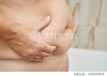 Woman Squeezing Breast Tissue While Wearing Nude Underwear In Bathroom Close Up Of Hand Compressing Woman Squeezing Breast Tissue While Wearing Nude Underwear In Bathroom Close Up Of Hand Compressing 143029945