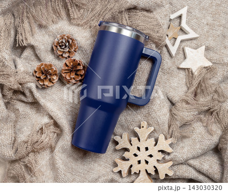 Dark blue tumbler mockup, blank stainless steel cup on beige blanket, Christmas rustic scene 143030320