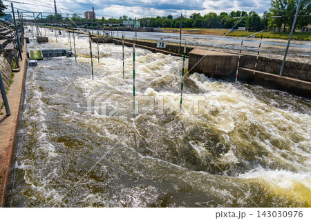 Artificial whitewater slalom course with numbered gates on the Vltava River in Prague Czech Republic. Outdoor kayaking training and canoe slalom concept for water sports and active recreation. 143030976
