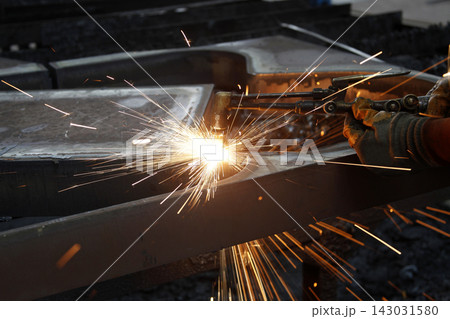 Industrial worker welding in steel factory 143031580