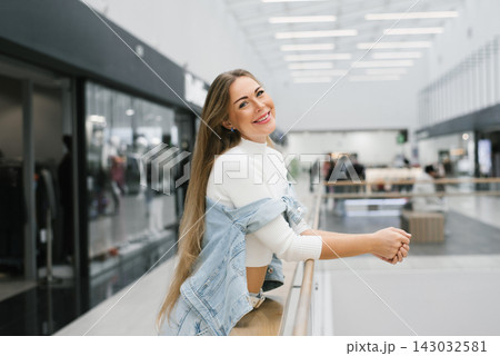 Customer Smiling and Leaning on Railing in Mall 143032581