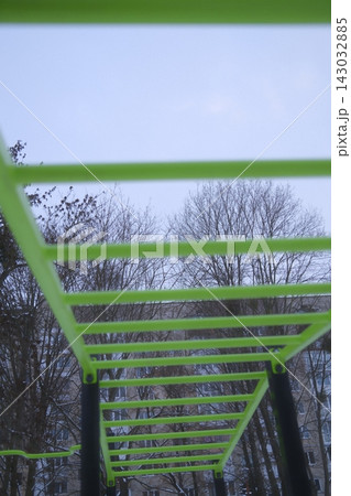 Bright green monkey bars at a city park during a cold winter morning 143032885