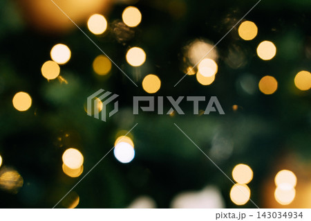Abstract bokeh lights with green and golden tones in soft focus 143034934