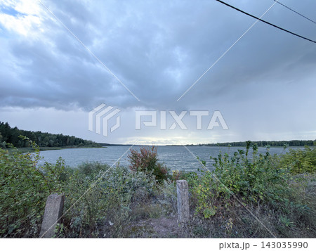 Overcast Lake Horizon Beneath Dramatic Gray Cloudy Sky 143035990