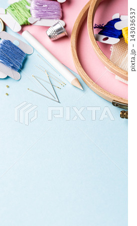 Colorful embroidery supplies arranged on a pastel background with copy space for design projects 143036537