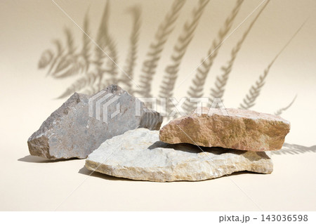 Podium with dry grass for product promotion and cosmetics display. Natural beige beauty pedestal. Background for product presentation. Cream stone podiums with shadow of leaf. Beauty product mockup 143036598