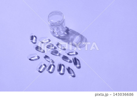Pills and glass pill bottle on yellow background. Big golden tablets. Omega 3 capsules. Close up, top view. Health care concept. Healthy every day fatty acids nutritional supplement dosage. Flat lay Pills and glass pill bottle on yellow background. Big golden tablets. Omega 3 capsules. Close up, top view. Health care concept. Healthy every day fatty acids nutritional supplement dosage. Flat lay 143036686