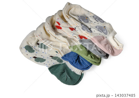 Neat stack of folded white ankle socks with diverse patterns and colorful heels 143037485