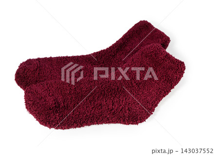 Pair of fluffy maroon fuzzy cozy socks isolated on white Pair of fluffy maroon fuzzy cozy socks isolated on white 143037552