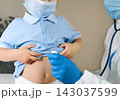 Medical examining boy in clinic. Little child checked by doctor. Pediatrician with stethoscope with face mask and toddler in a hospital. Check heart lungs of kid. Pediatric checkup in hospital 143037599