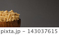 Gluten Free Cornmeal Pasta in wooden Bowl. Spiral Raw Macaroni from Blend of Corn and Rice flour. Close Up, Front View. Uncooked Bucati Pasta. Food Background. Horizontal banner with space for text 143037615