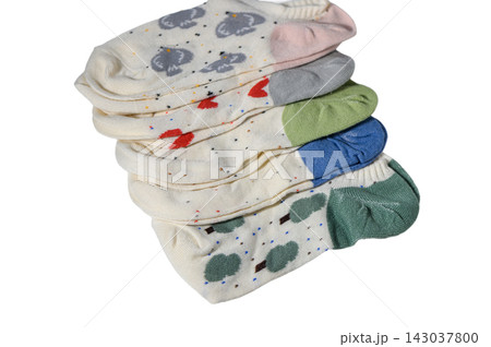 Stack of folded cute patterned ankle socks with various designs 143037800