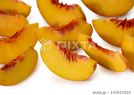 Commercial stock photo of fresh sliced peach wedges with juicy pulp and red pit cavities Commercial stock photo of fresh sliced peach wedges with juicy pulp and red pit cavities 143037810