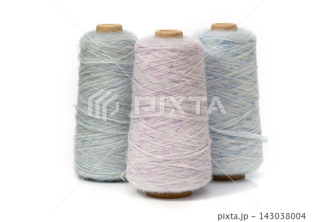 Soft pastel threads lined up, inviting creativity and inspiration in a warm crafting space Soft pastel threads lined up, inviting creativity and inspiration in a warm crafting space 143038004