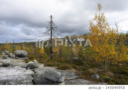 Autumn landscape with a rocky plateau under an impressive cloudy sky. 143040958