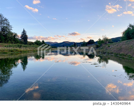 Traisen river landscape reflecting cloudy sky at sunset in Lower Austria 143040964