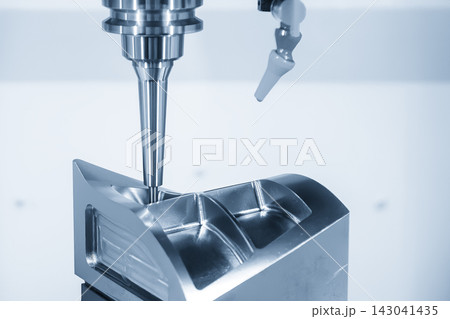 5-axis CNC milling machine finishing a metal mold part with a ball nose end mill in blue tone 5-axis CNC milling machine finishing a metal mold part with a ball nose end mill in blue tone 143041435