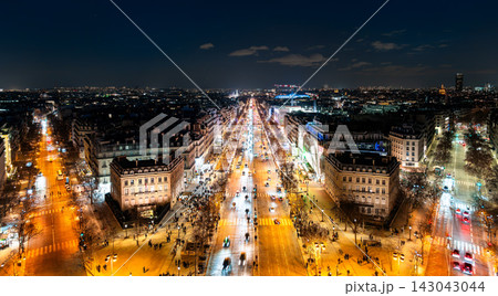 Night view of traffic and Haussmann buildings along the Champs-Elysees avenue illuminated for Christmas in Paris, France. Night view of traffic and Haussmann buildings along the Champs-Elysees avenue illuminated for Christmas in Paris, France. 143043044