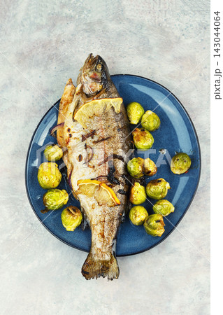 Fried Trout with Brussels Sprouts. 143044064