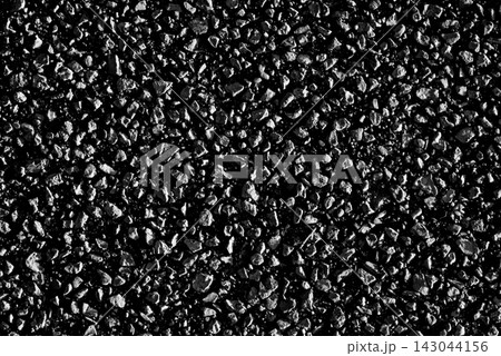 Abstract background texture of thousands of tiny black asphalt stone grains 143044156