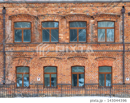 Four windows of the old mansion 19 century with brown bricks wall 143044396