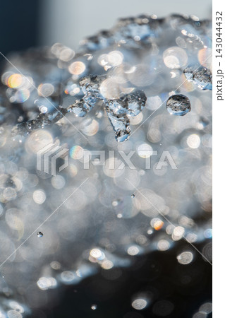 Splashes and jets of water against light background. Splashes and jets of water against light background. 143044432