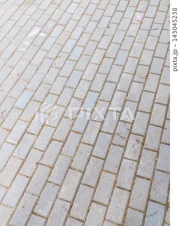 Rhythmic Grey Concrete Paving Slabs Texture on Urban Sidewalk 143045238