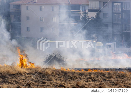 Flames and Smoke Rising from an Urban Grassland Fire. Flames and Smoke Rising from an Urban Grassland Fire. 143047199