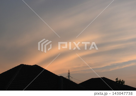 roof of house on beautiful golden sky and white cloud background in springtime 143047738