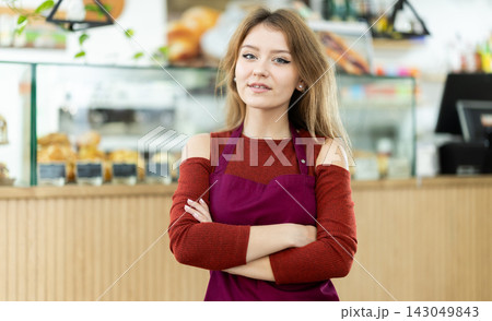 Female cafe employee greets guests of establishment 143049843