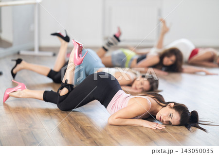 Female dancer in high heels performing contemporary dance on floor Female dancer in high heels performing contemporary dance on floor 143050035