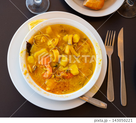 Traditional Spanish soup with seafood in a bowl view from above 143050221