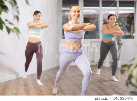Three women doing fitness in fitness studio 143050476