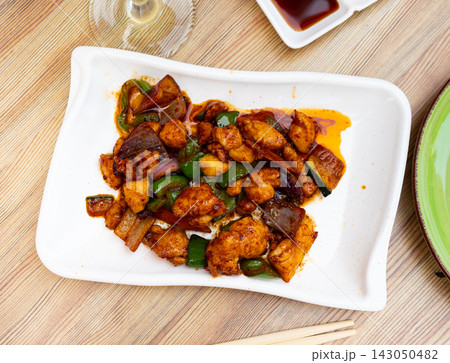 Tasty chicken pieces in in satay sauce with stewed eggplant and peppers 143050482