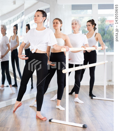 Girls in ballet class perform Batman with participation of mature female mentor Girls in ballet class perform Batman with participation of mature female mentor 143050693