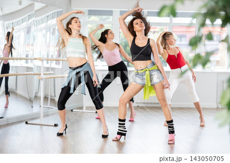 Group of women dancing high heels in studio Group of women dancing high heels in studio 143050705