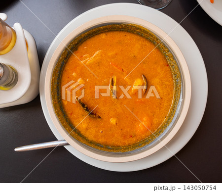 Spicy Mediterranean soup made with seafood and thin noodles. Spicy Mediterranean soup made with seafood and thin noodles. 143050754