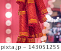 Decorative red firecrackers with shining sequins and gold bands for a vibrant holiday celebration 143051255